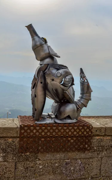 A vertical shot of a metal statue of a dog in San Marino