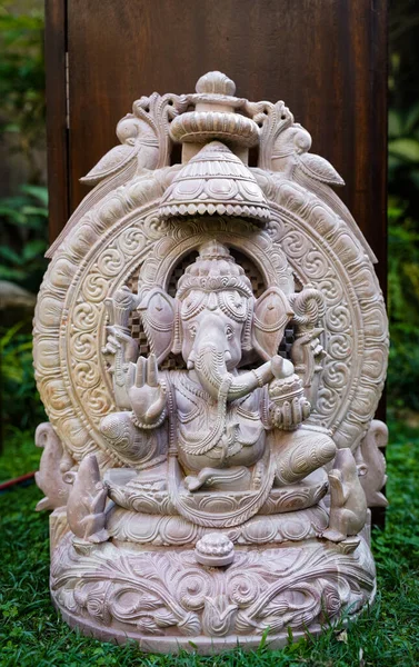 A closeup of a sculpture of an Indian deity