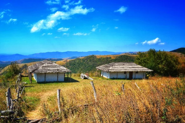 A view of cabins in the field of Ukrainian Carpathians