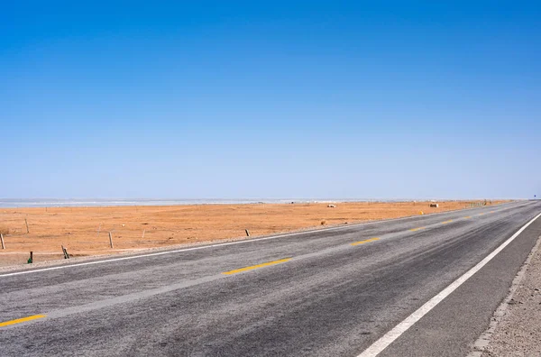 Uma Estrada Asfalto Passando Lado Uma Área Deserta Sob Céu — Fotografia de Stock