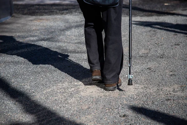 通りに杖を持つ老人 路上の影 障害のための概念 太りすぎ ラメ人 足の病気 — ストック写真