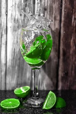 Limonlu ve naneli bir bardağın dikey görüntüsü.