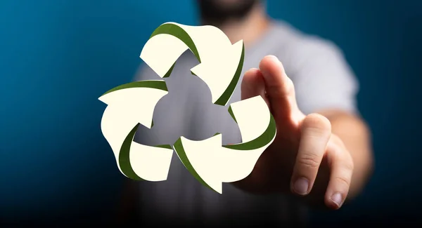 A hand pointing to a digital recycling sign on a blurred background