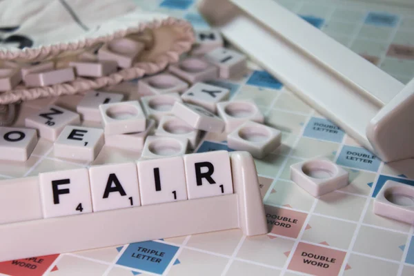 Closeup Word Fair Spelling White Scrambling Board Game — Stock Photo, Image