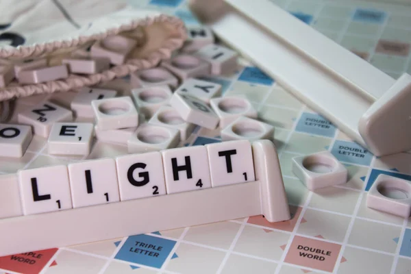 Closeup Word Light Spelling White Scrambling Board Game — Stock Photo, Image