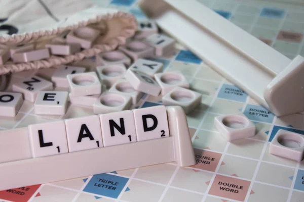 Closeup Word Land Written White Scrambling Board Game — Stock Photo, Image