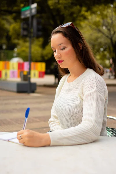 Una Hermosa Foto Una Mujer Hispana Escribiendo Algo Cuaderno —  Fotos de Stock