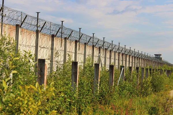 ソ連のロシア刑務所の敷地内に有刺鉄線付きの大きな石壁 — ストック写真