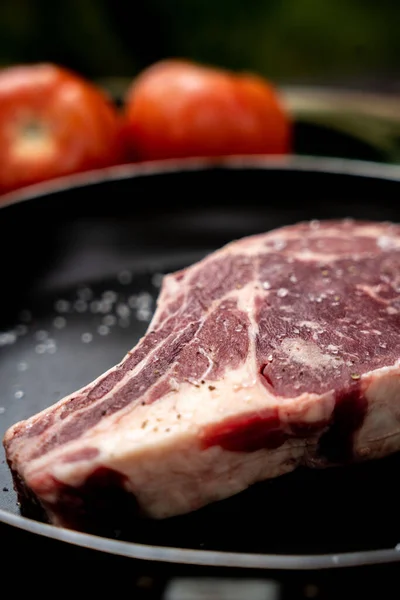 Domatesli Baharatlı Bir Kemik Üzerinde Çiğ Biftek — Stok fotoğraf