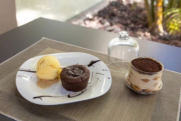 Egy Csokis Pite Vaníliás Jégkrémmel Fehér Tálcán Tálalva Asztalon — Stock Fotó