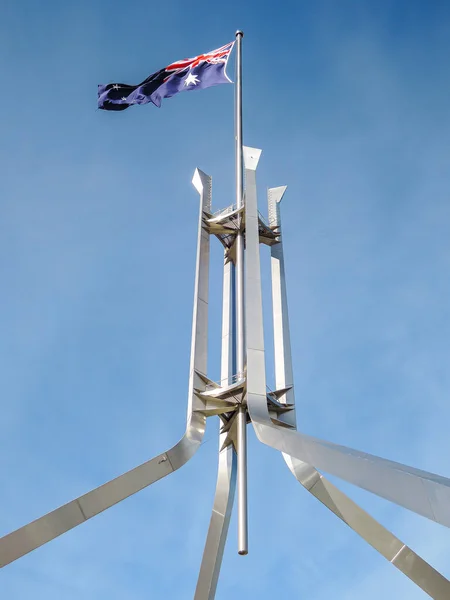 A vertical shot of the Australian flag on top of Parliament in Canberra