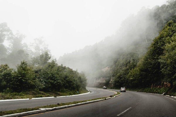 A foggy road among mountains and forests in Guatemala