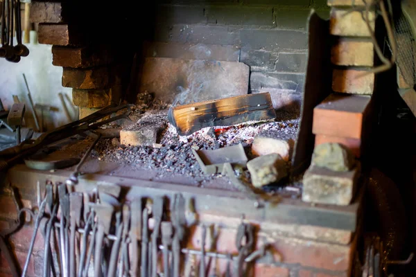 A selective of burning wood in a fireplace in a smithy