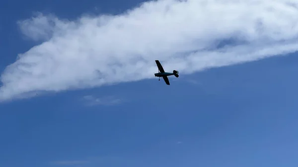 A small plane flying in the sky