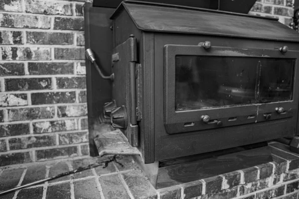 Grayscale Shot Old Wood Stove Brick House — Stock Photo, Image