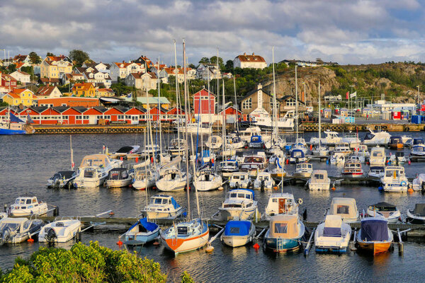 A beautiful view of a fishing village with colorful houses and  boats in Skaftoe, Grundsund, Sweden
