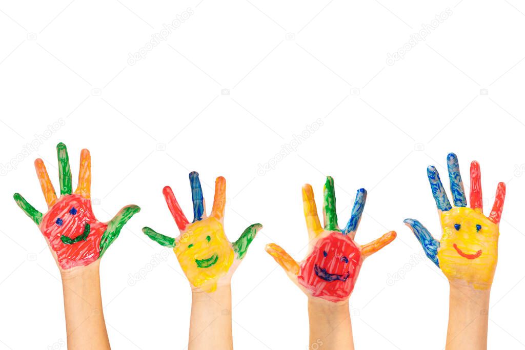 A closeup of colorful painted hands with smiley faces on a white background