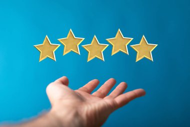 Mavi arka plandaki bir adamın avucunda süzülen beş yıldızlı bir üç boyutlu tasarım.