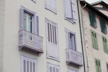 Ax-les-Thermes 'deki beyaz binanın balkonları. Fransa.