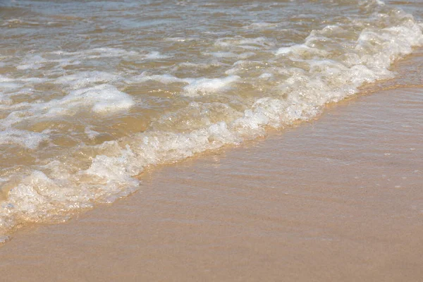 晴れた日に砂浜に波が打ち寄せる — ストック写真