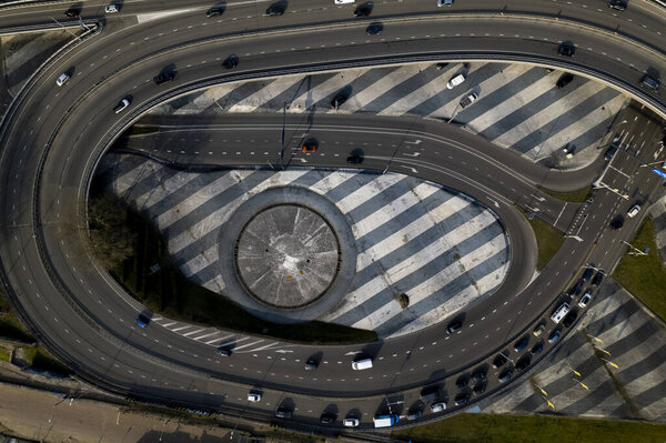 Top down aerial view of transit roundabout intersection near Utrecht in Dutch landscape.