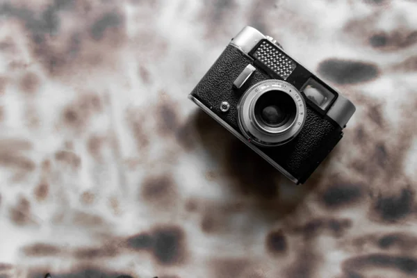 A closeup of a vintage camera on a white background with the burnt spots