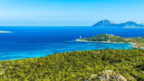 A beautiful view of clear water surrounded by the rocky seashore on Sardinia island