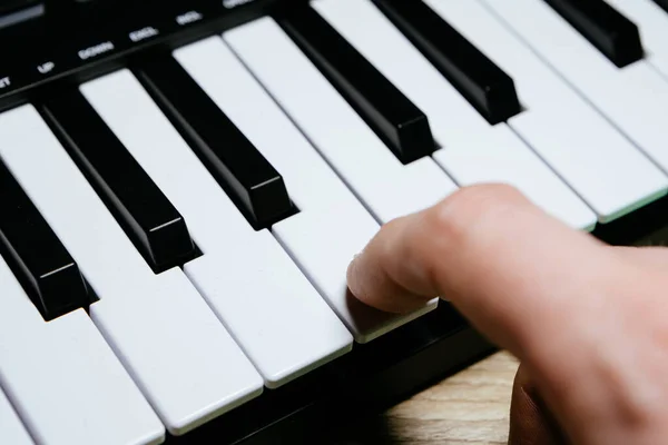 A finger on the key of piano