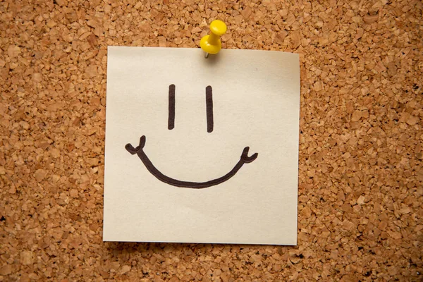 Een Stuk Papier Met Een Smiley Face Pin Een Kurkbord — Stockfoto