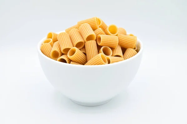 Closeup Raw Rigatoni Pasta White Bowl White Background — Stock Photo, Image