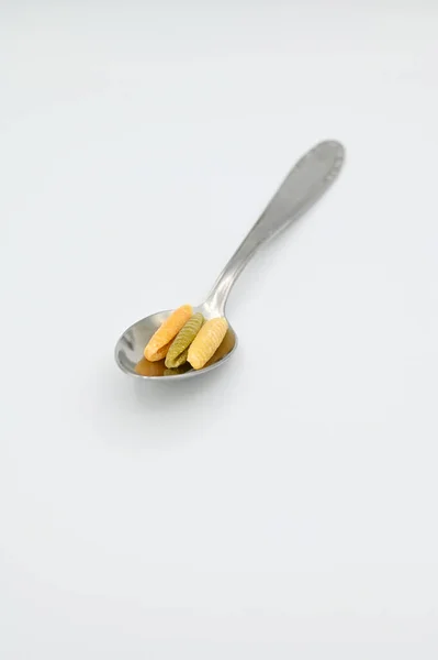 Vertical Shot Colorful Raw Malloreddus Pasta Spoon White Surface — Stock Photo, Image