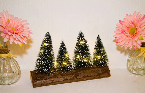 Closeup Four Small Christmas Trees Yellow Lights Wooden Surface Next — Stock Photo, Image