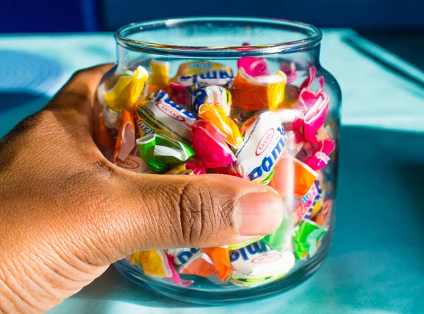 Closeup Man Hand Holding Glass Jar Full Colorful Hard Candy — Stock Photo, Image