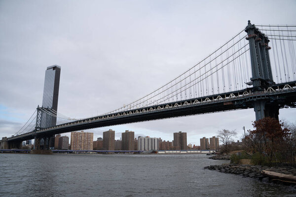 A beautiful view of the Manhattan bridge under the cloudy sky