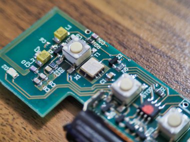 Ahşap bir masada yeşil bir elektronik modül.