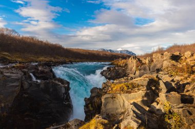 Bruarfoss Şelalesinin, Brekkuskogur, İzlanda 'da mavi bulutlu bir gökyüzüne bakan güzel bir manzara.