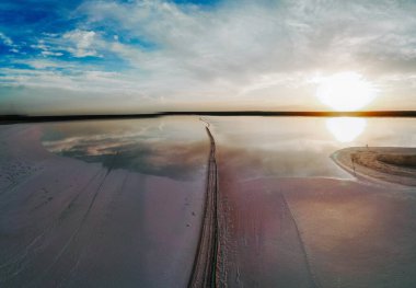 Bulutlu arka planda okyanusu olan bir sahilin havadan görünüşü.