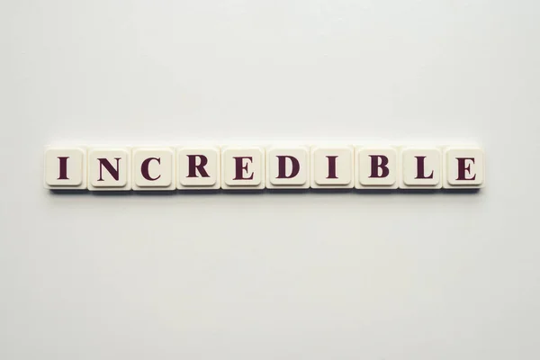 Closeup Scrabble Tiles Letters Spelling Message Incredible White Background — Stock Photo, Image