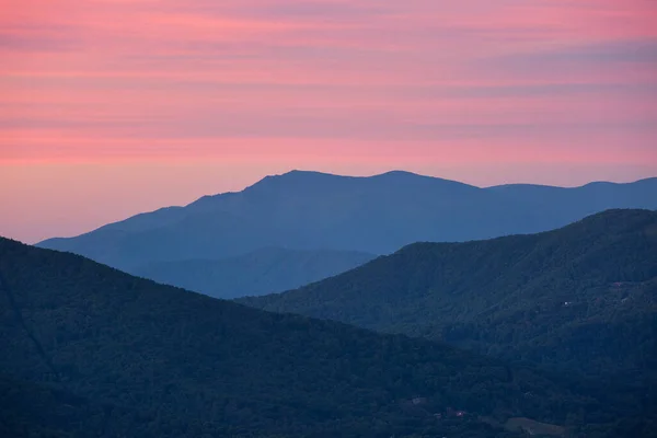 The silhouettes of the Blue Ridge mountains in North Carolina at sunset.