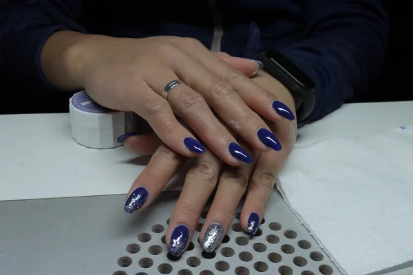 a closeup shot of blue studio nails