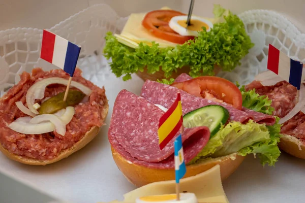 A closeup of meals with different flags pitched on them