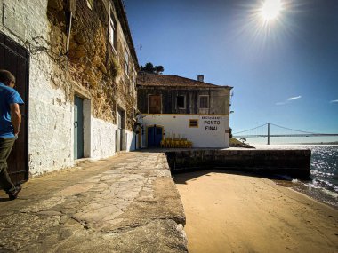 Tagus nehri kıyısında küçük kumlu bir sahili olan güzel bir resim.