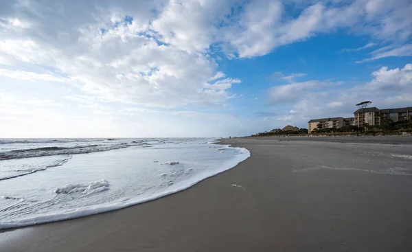 A beautiful shot of the beach in Hilton Head South Carolina hotel under a blue cloudy sky