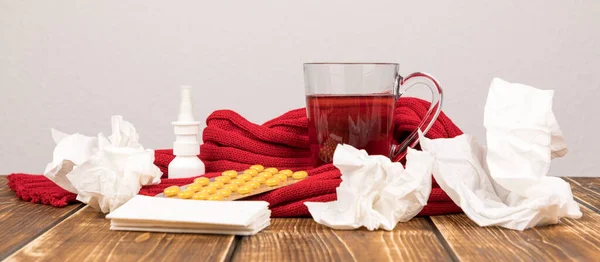 Cup Herbal Tea Pills Tissues Scarf Nasal Spray Wooden Surface — Stock Photo, Image