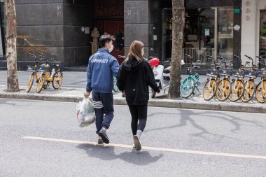 Bir çift, COVID19 salgını sırasında kilit altına alınmak üzere süpermarketten gerekli malzemeleri almaya gidiyorlar.