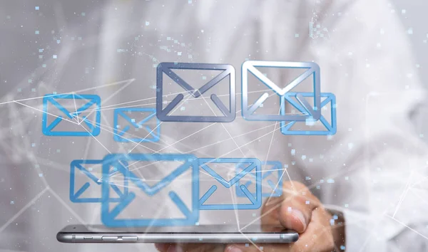 A hologram of email icons projecting from a man's tablet. E-communication concept