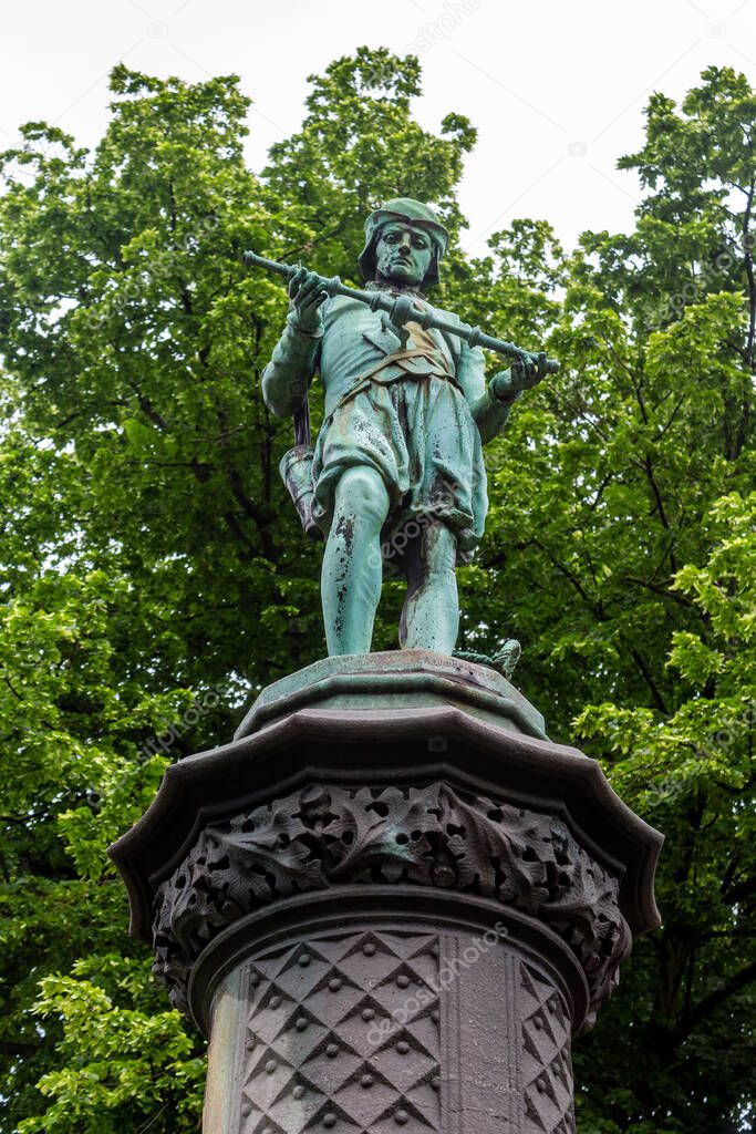 An impressive vertical shot of a blue statue in the Petit Sablon Square, Brussels, Belgium