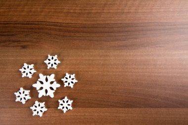 Tahta bir zeminde beyaz kar tanelerinin üst görüntüsü
