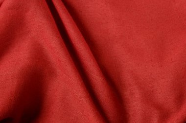 Kırmızı pamuklu kumaşın yakın plan çekimi.