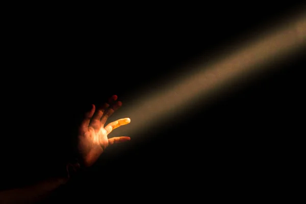 Hand Reaching Out Beam Light Black Background — Stock Photo, Image